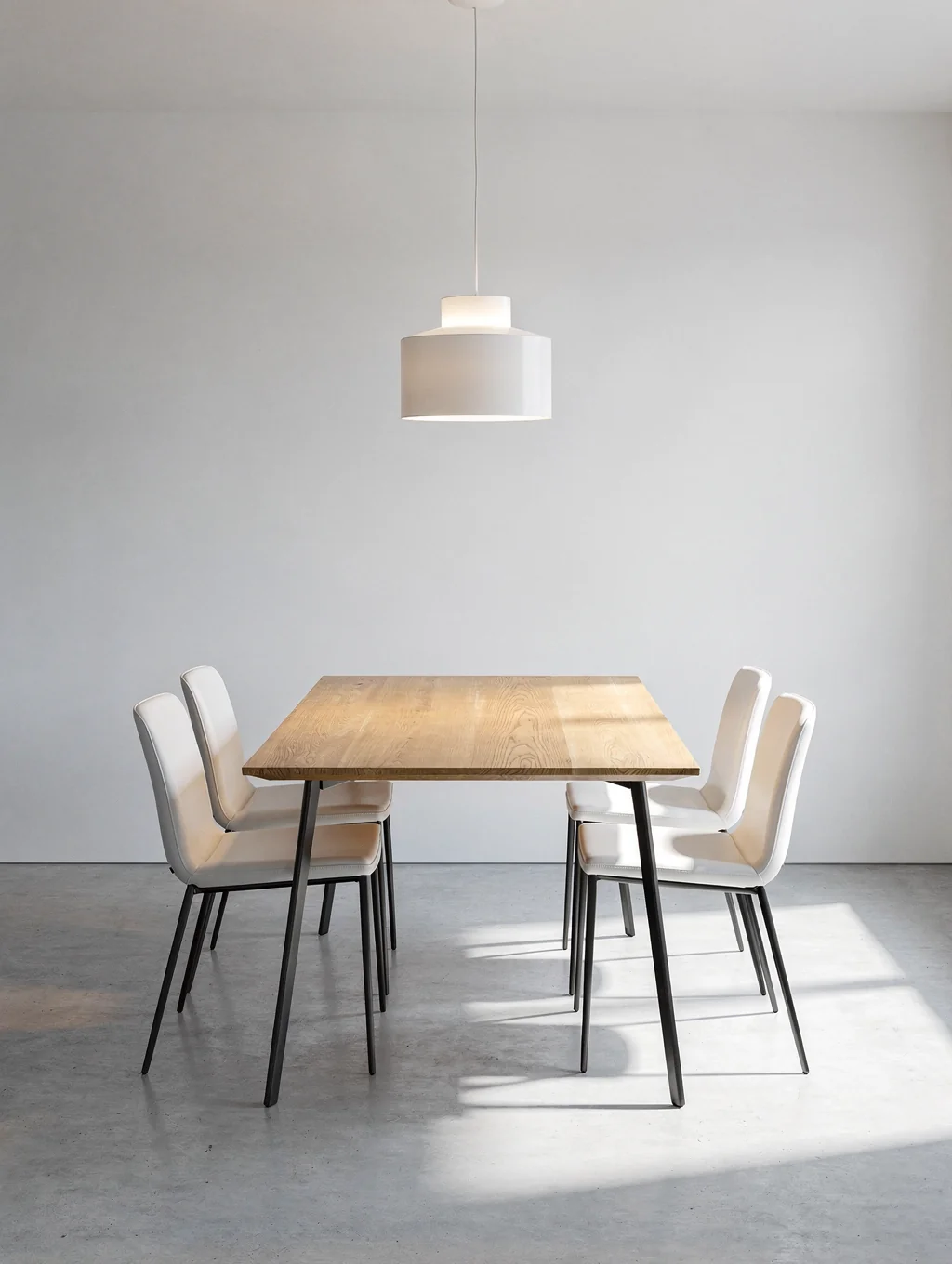 Minimalist contemporary dining room with earthenware table settings and warm ambient lighting